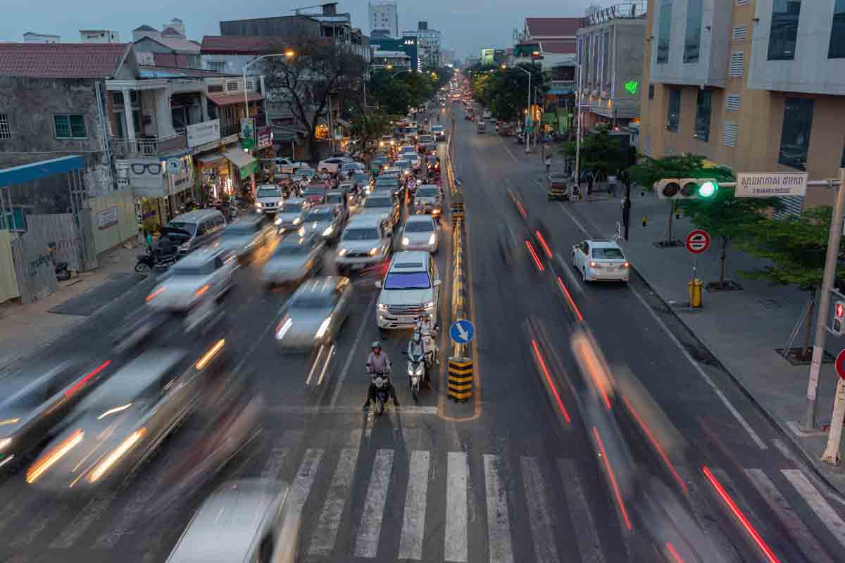 Chaotic traffic on a Phnom Penh street at dusk