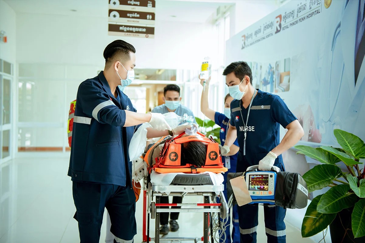 Emergency medical team at Royal Phnom Penh Hospital treating a patient on a stretcher