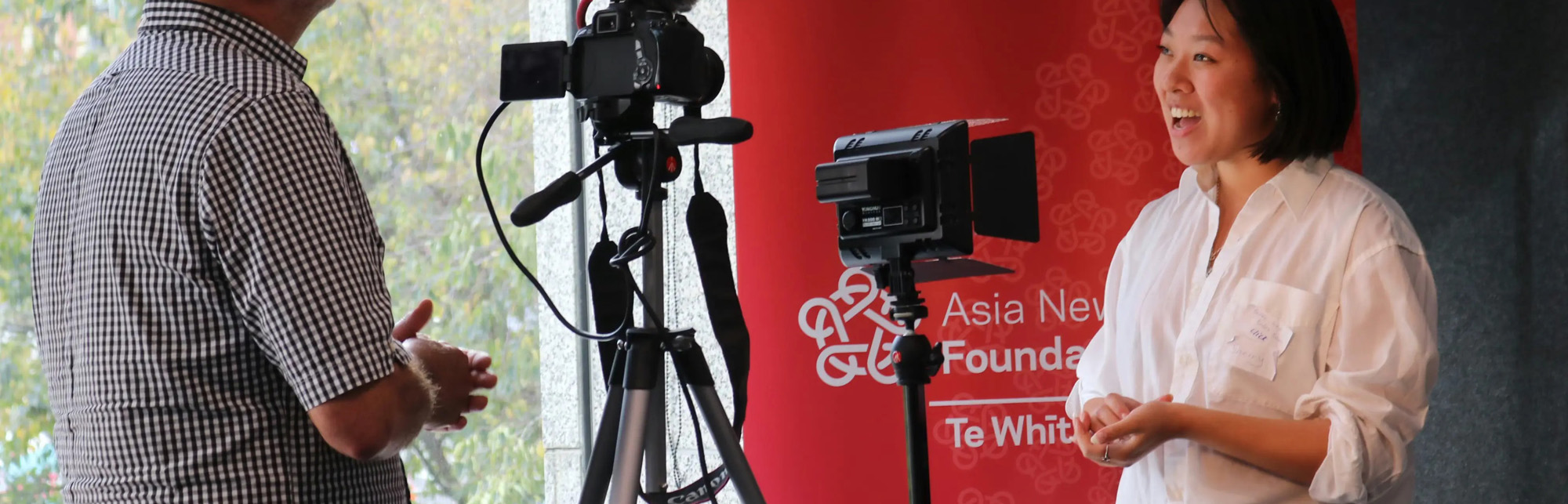 Journalist interviewing a spokesperson on camera — Southeast Asia